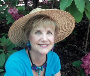 Benita A. Esposito, MA, a licensed therapist and spiritual coach for highly sensitive introverts, smiling warmly with a lush, green garden in the background.