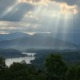 Dramatic sunbeams breaking through storm clouds over Lake Chatuge and the Blue Ridge Mountains.