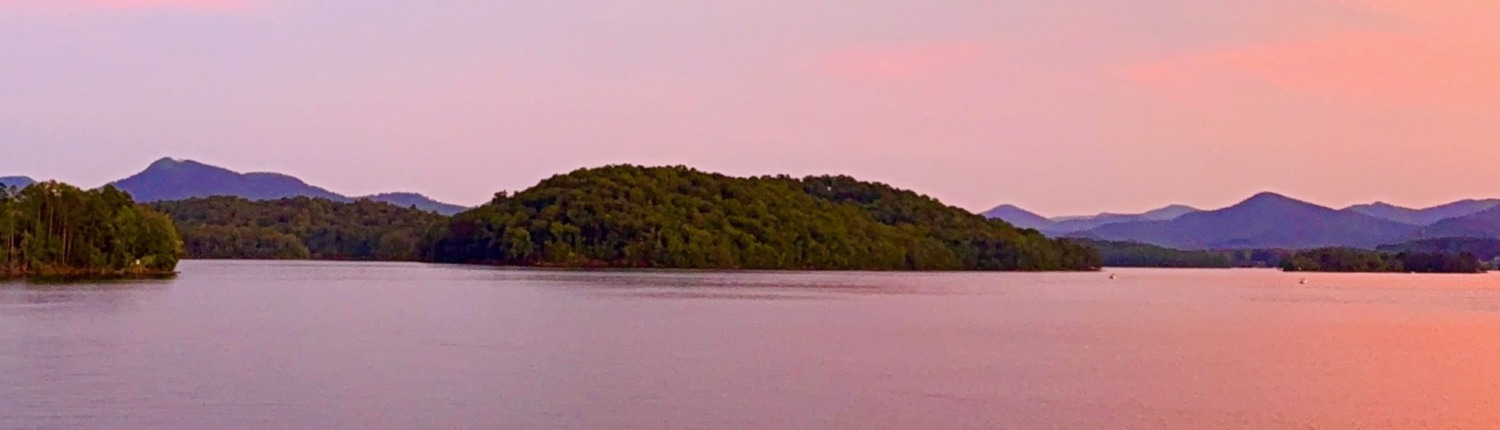 A panoramic view of the Blue Ridge Mountains and Lake Chatuge at sunset, a serene setting for an HSP Retreat.