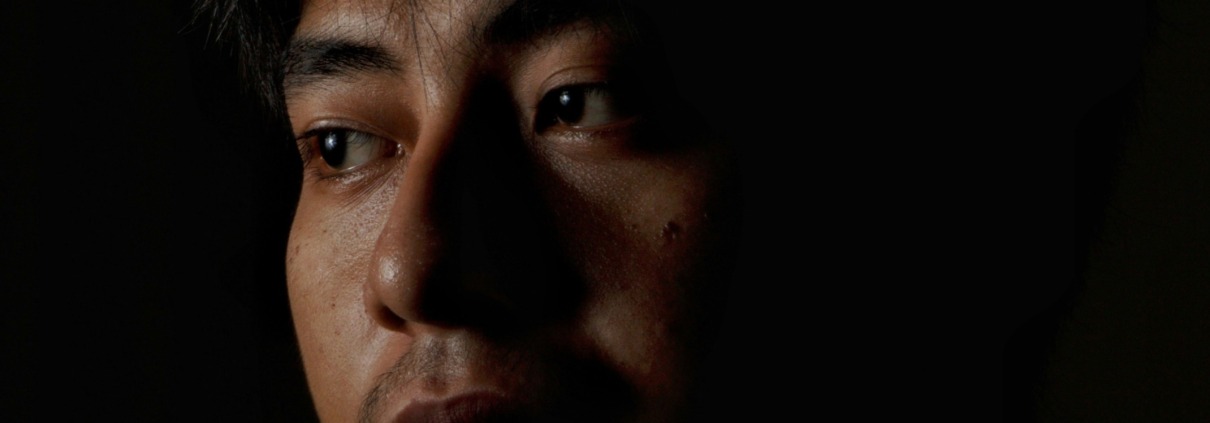 Portrait of a highly sensitive Christian man emerging from shadow into light, symbolizing emotional healing, profound forgiveness, and inner peace.
