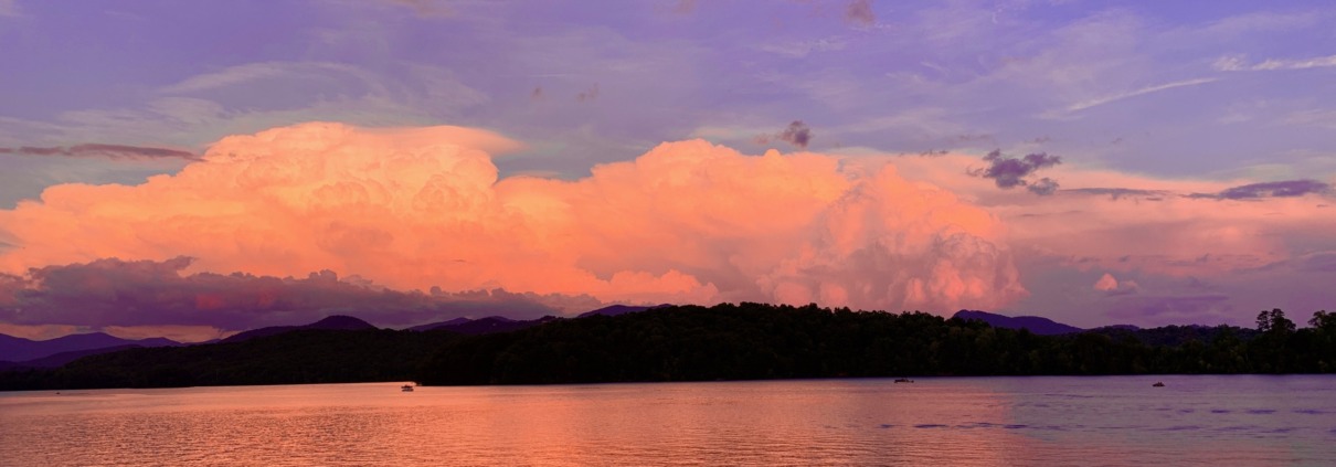 Panoramic view of peach sunset clouds reflecting on Lake Chatuge and the Blue Ridge Mountains near Young Harris, GA.
