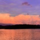 Panoramic view of peach sunset clouds reflecting on Lake Chatuge and the Blue Ridge Mountains near Young Harris, GA.
