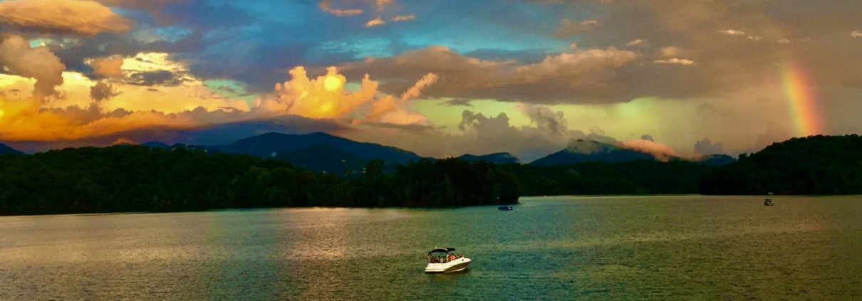 Sunset over Lake Chatuge and the Blue Ridge Mountains with a rainbow, the serene venue for Krista's HSP Retreat.
