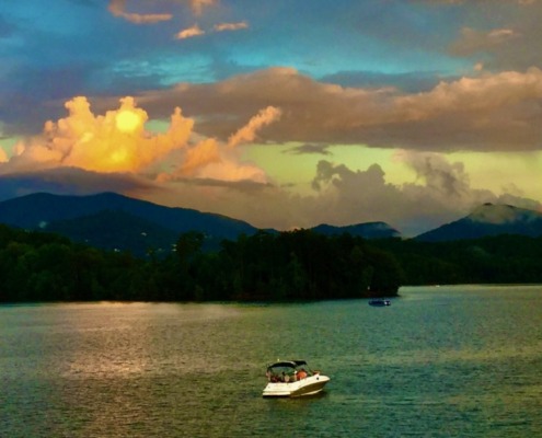 Sunset over Lake Chatuge and the Blue Ridge Mountains with a rainbow, the serene venue for Krista's HSP Retreat.