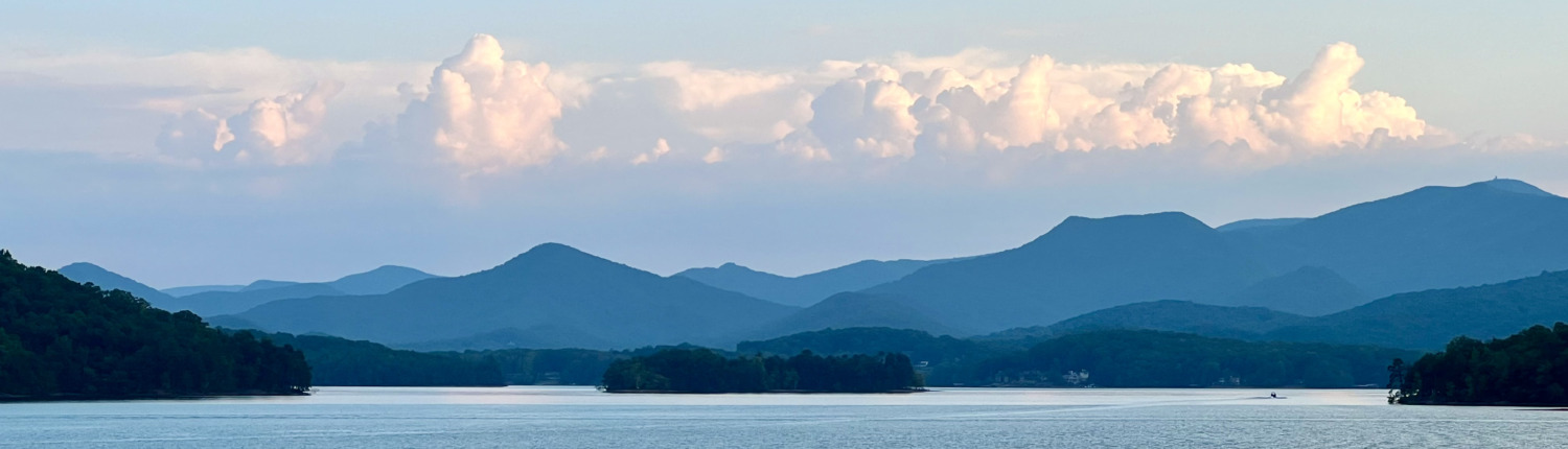 Gorgeous panoramic view of white clouds above the Blue Ridge Mountains at Lake Chatuge in Young Harris, Georgia where Benita Esposito facilitates intensive Retreats for highly sensitive people