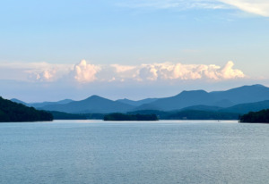 Serene view of Lake Chatuge in Young Harris, Georgia, with layers of blue mountains fading into a soft horizon.
