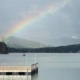 A vibrant rainbow breaking through storm clouds over Lake Chatuge in Young Harris, Georgia.