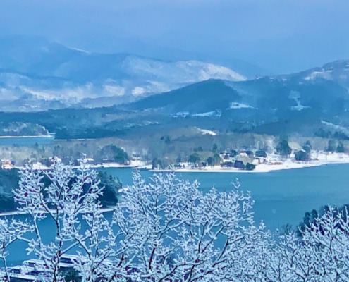 Snow-covered Blue Ridge Mountains and branches overlooking Lake Chatuge, the venue for Ellen's HSP Retreat.