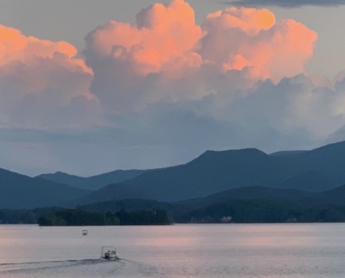 Sunset over Lake Chatuge in NC and GA, featuring peach clouds over the Blue Ridge Mountains, venue of our HSP Retreats.