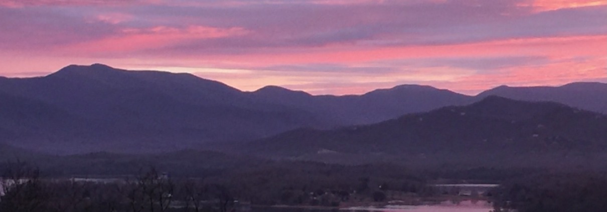 Panoramic view of a pink sunrise over the Blue Ridge Mountains and Lake Chatuge in Young Harris, Georgia.