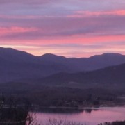 Panoramic view of a pink sunrise over the Blue Ridge Mountains and Lake Chatuge in Young Harris, Georgia.