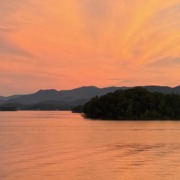 Panoramic orange sunset over Lake Chatuge and the Blue Ridge Mountains near Young Harris, Georgia.