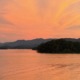 Panoramic orange sunset over Lake Chatuge and the Blue Ridge Mountains near Young Harris, Georgia.