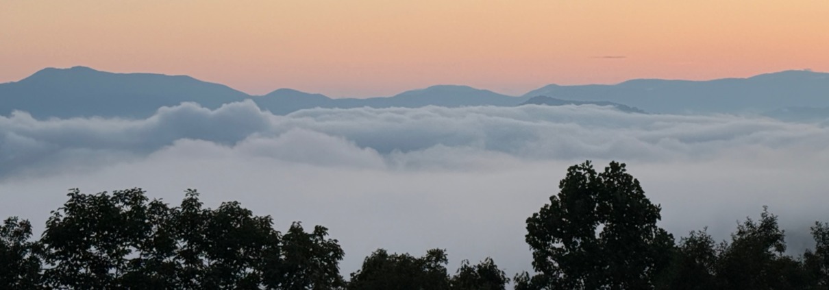 Scenic morning clouds over the Blue Ridge Mountains during a highly sensitive person (HSP) retreat.