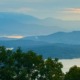 A scenic, peaceful view of the misty Blue Ridge Mountains and Lake Chatuge at dawn, captured by Benita A. Esposito to evoke emotional healing, calmness, and stillness for highly sensitive introverts.